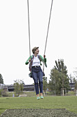 Mature woman swinging in park