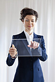 Attractive Mid Adult Businesswoman Touching On Blank Transparent Digital Tablet