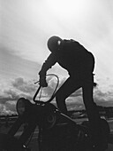 A man standing on a motorcycle