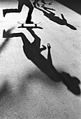 Silhouetted skateboarders