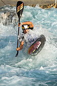 Slalom paddler turning in waves, Al-Ain, Dubai, UAE