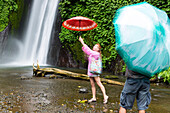 Tourists with umbrellas, Air Terjun Munduk waterfall, Munduk, Bali, Indonesia