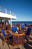 Outdoor seating at bar Zum Alten Fritz aboard cruise ship MS Deutschland (Reederei Peter Deilmann), Atlantic Ocean, near Portugal