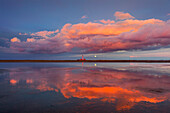 Lighthouse, clouds and moon reflecting in the flats near Westerhever lighthouse, Eiderstedt peninsula, Schleswig-Holstein, Germany