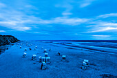 Roofed wicker beach chairs at beach in twilight, Kampen, Sylt, Schleswig-Holstein, Germany
