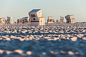 Roofed wicker beach chairs at beach, Kampen, Sylt, Schleswig-Holstein, Germany