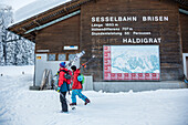 Two skiers passing station at the bottom of a ski lift, free ride skiing area Haldigrat, Niederrickenbach, Oberdorf, Canton of Nidwalden, Switzerland