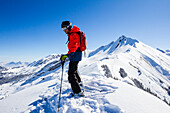 Skier standing on a mountain top, free ride skiing area Haldigrat, Niederrickenbach, Oberdorf, Canton of Nidwalden, Switzerland