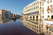 reflection of palazzi on roof of water taxi on the Canal Grande, Motoscafi, Venice, Italy