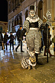 Venetian Carnival, tourism, masks, harlequin, costume, black and white, posing, dog, Venice, Italy
