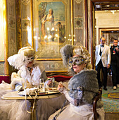 Carnival Venice, Caffè Florian, masked ladies in carnival dress, old traditional coffee house, Piazza San Marco, Venice, Italy