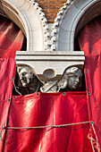 Pescheria Nuova, detail, capital, head of column, red tarpaulin of Rialto fish market, white pillar, Venice, Italy