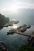 The early morning view of cruise boats anchored at Sun Moon Lake, Taiwan.