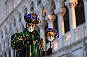 A masked harlequin at the carnival in Venice, Italy, Europe