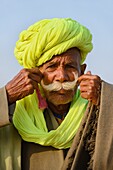 India, Rajasthan, Pushkar, Rajput straightening his moustache.