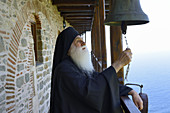 Greece, Chalkidiki, Mount Athos, listed as World Heritage, Simonos Petra monastery, Father Ephrem ringing the bell.