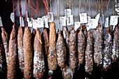 Corsican traditional sausages in a tent city of St-Florence tourist, France, Europe.