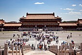 Beijing, China-August 5, 2010: Despite the strong heat in Beijing in August, thousands of tourists visit the Forbidden City each day, shielding the sun with umbrellas.