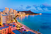 Hawaii, Oahu, Waikiki, View Of Hotels Along Ocean And Diamond Head In The Evening.