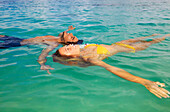 Hawaii, Young Couple Floating In Tropical Ocean Water.