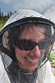 Woman wearing a head net to keep mosquitos out