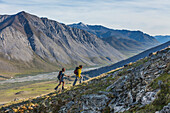 Hikers in the mountains bordering the Marsh Fork of the Canning river in the Arctic National Wildlife Refuge, Brooks range mountains, Alaska.