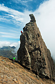 'People abseil off the Inaccessible Pinnacle at the summit of Sgurr Dearg; Isle of Skye, Scotland'
