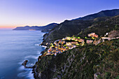 'Riomaggiore and the coastline at dusk, Cinque Terre; Liguria, Italy'