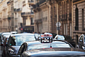 'A taxi in traffic; Paris, France'