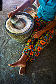 'A woman grinding wheat; Ulpotha, Embogama, Sri Lanka'
