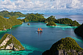 'Tiger Blue Phinisi schooner sailing through Pulau Wayag Islands of Raja Ampat; Indonesia'