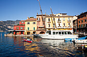'Boats in the harbour and buildings along the water's edge; Malcesine, Verona, Italy'