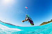 'Professional kiteboarder Susi Mai kitesurfing over the crystal blue waters, Necker Island, British Virgin Islands'