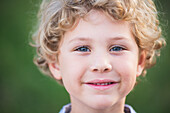 'Portrait of a young boy with blond curly hair and blue eyes; Pittsboro, North Carolina, United States of America'