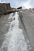 A climber leads the first ascent of a difficult ice climb in early fall on 14,000 foot Longs Peak. The floods of September 2013 made for excellent ice climbing in the Colorado High Country.