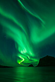 Northern Lights - Aurora Borealis shine in Sky over Vik Beach, Vestv?•g??y, Lofoten Islands, Norway