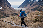 Female hiker hiking trail towards Horseid beach, Moskenes??y, Lofoten Islands, Norway