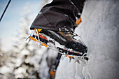 Boots and crampons on an ice wall in Whistler, British Columbia, Canada.