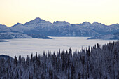 Glacier National Park peaks at sunrise with an inversion.