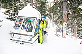 A male skier stops by a gondola fort at Big Sky Resort the largest ski resort in the United States by acreage with 5,750 acres, 30 lifts and a vertical drop of 4,350 feet located in Big Sky, Montana.