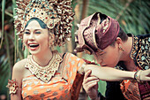 Couple enacting wedding scene in preparation for religious ceremony.Bali. Indonesia