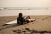 Girl with surfboard on the beach. Bali.Indonesia