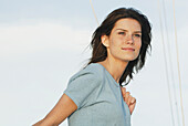 Young Woman Wearing Hemp Shirt Holds Rope On Sailboat, Clear Lake, Riding Mountain National Park, Manitoba, Canada