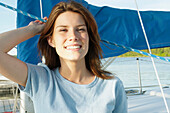 Young Woman Wearing A Hemp Shirt On Sail Boat, Clear Lake, Riding Mountain National Park, Manitoba, Canada