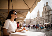 Young woman enjoying Espresso at restaurant, Piazza Navona, Rome, Italy, Europe