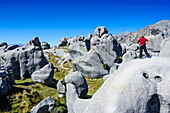 Woman standing on the limestone outcrops of Castle Hill, Canterbury, South Island, New Zealand, Pacific