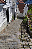 Steep cobbled street and white wooden houses, Old Stavanger (Gamle Stavanger), Stavanger, Norway, Scandinavia, Europe