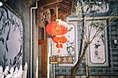 Chinese lanterns and wall paintings in an alley of Lijiang's Old Town, UNESCO World Heritage Site, Lijiang, Yunnan, China, Asia
