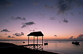 A pier at sunset on the beach of the St. Regis Hotel on Le Morne Brabant Peninisula, south west coast of Mauritius, Indian Ocean, Africa