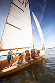 Children in a sailing boat on lake Starnberg, Upper Bavaria, Bavaria, Germany